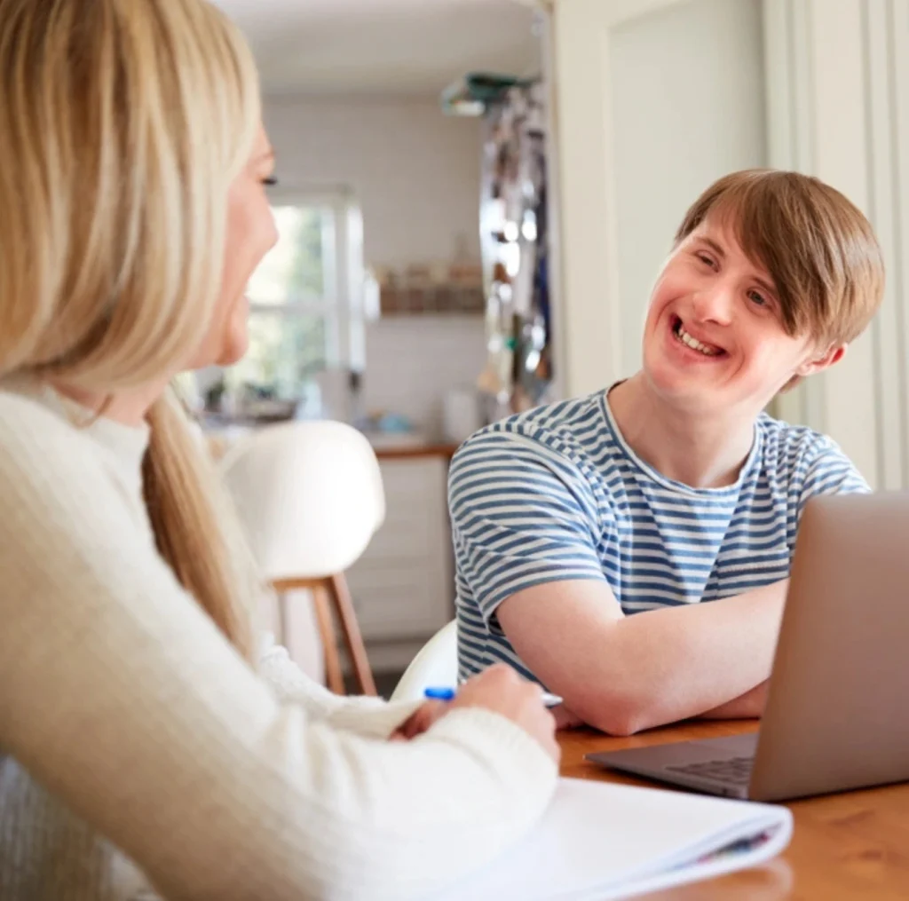 carer talking with a disabled young boy