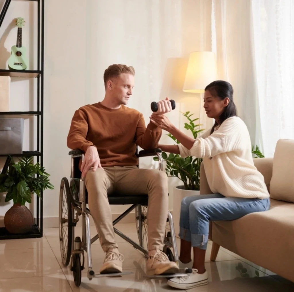 disabled men on wheelchair exercising with help of a carer